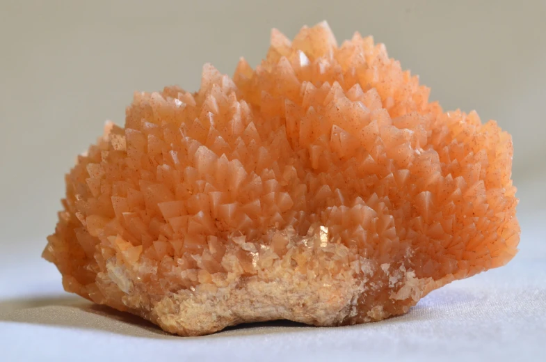 a small piece of orange colored rock with little glitter