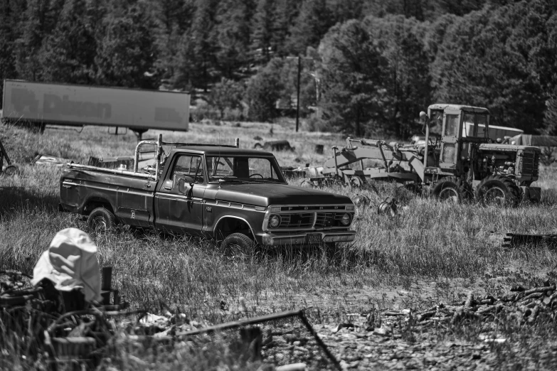 a couple of trucks in a grassy field