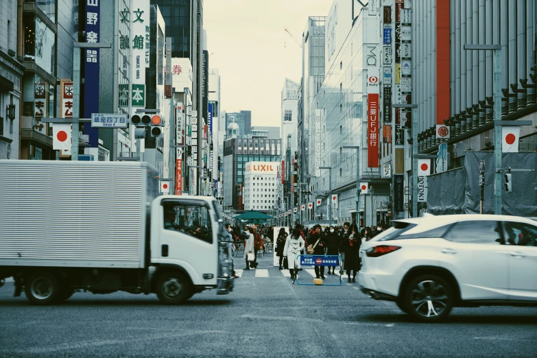 people walking down the street in an asian city