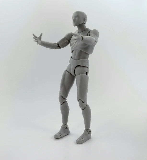 a gray robot posed on a white background