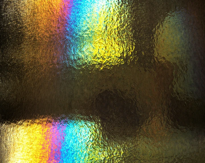 a lot of rain drops and colorful light on a window
