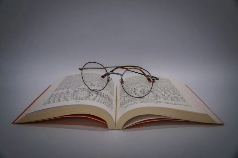 a book with glasses laying on it