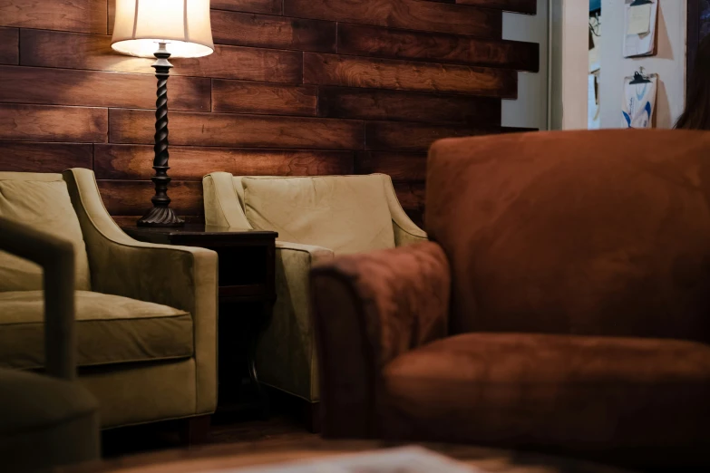 a living room with leather furniture and a lamp