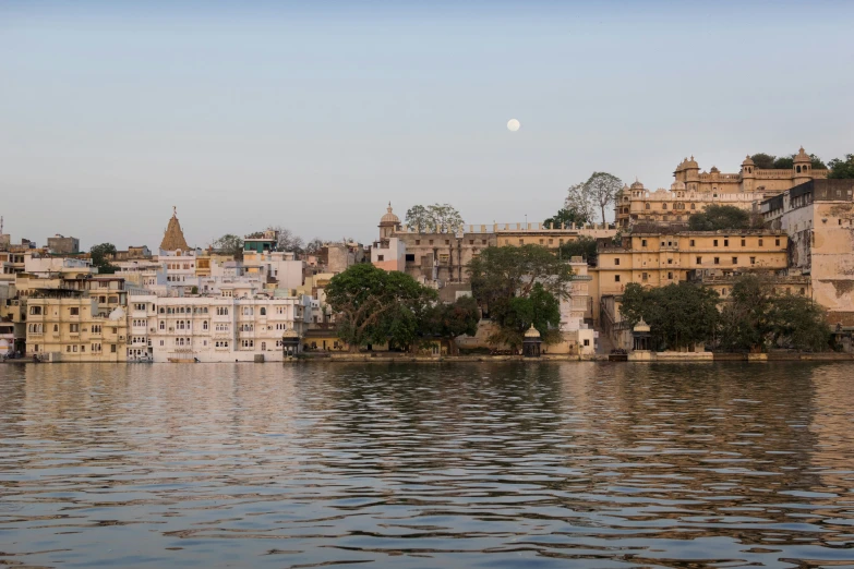 an old city and several towers sitting above a lake