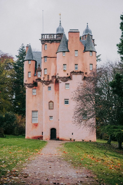 an old castle sits in a field of grass