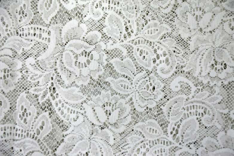 the white fabric has lacy details that can be seen on it