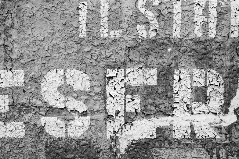 a street sign sitting on the side of a brick wall