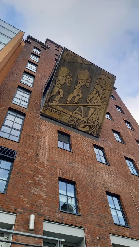 a sign on a building on top of the outside of it