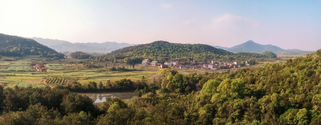 a view of the mountainous mountains and green valley