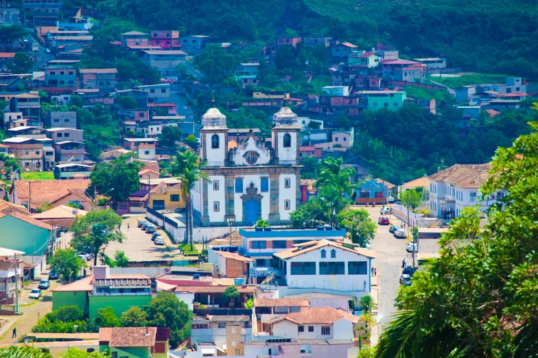 small town perched on mountain with village below