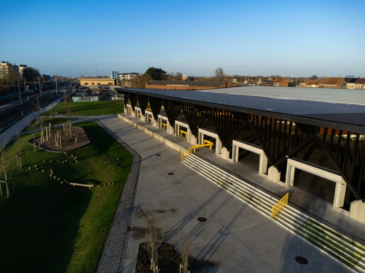 a train station that has a train and a field