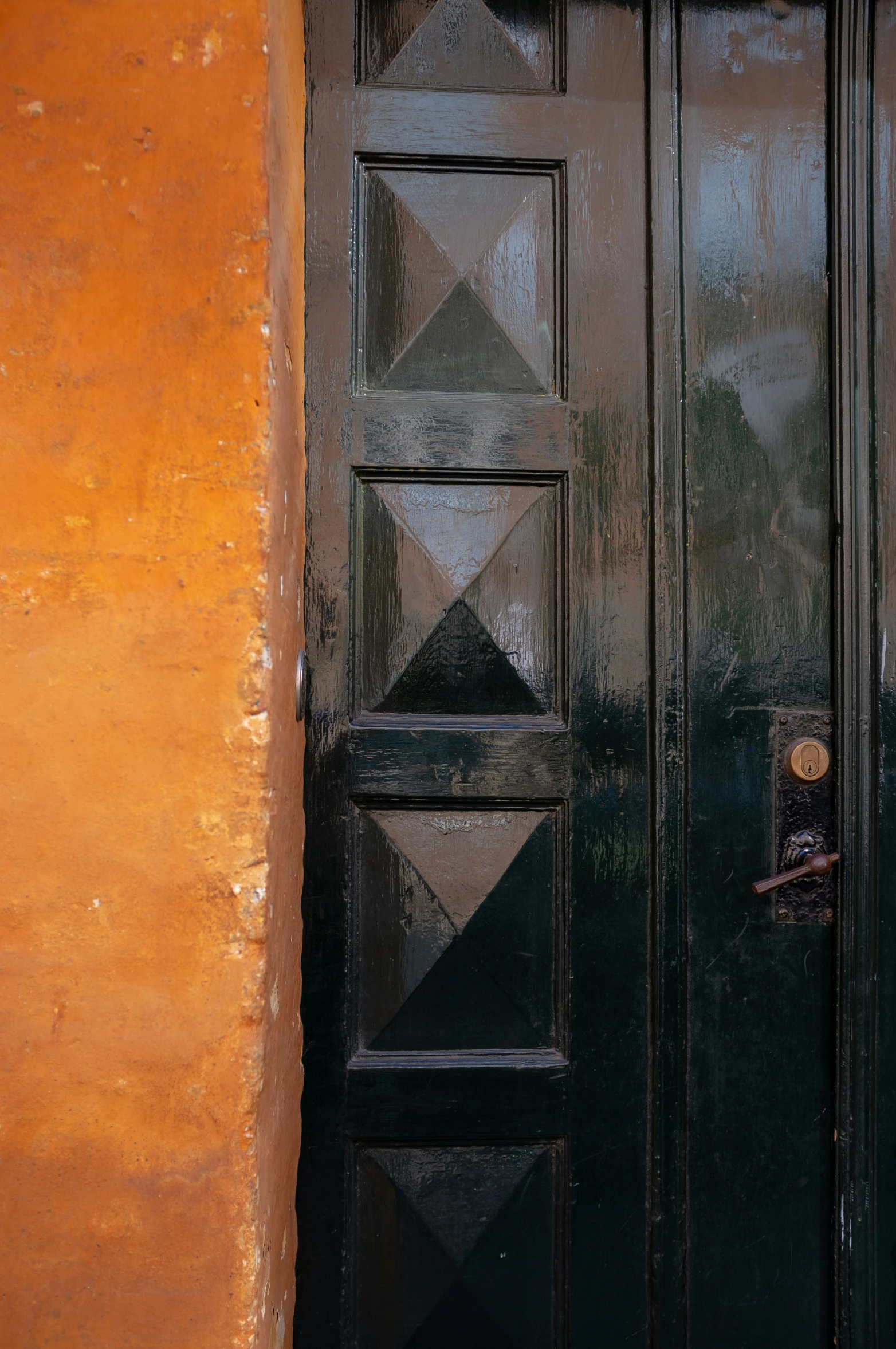 there is a black door with a diamond pattern on the glass