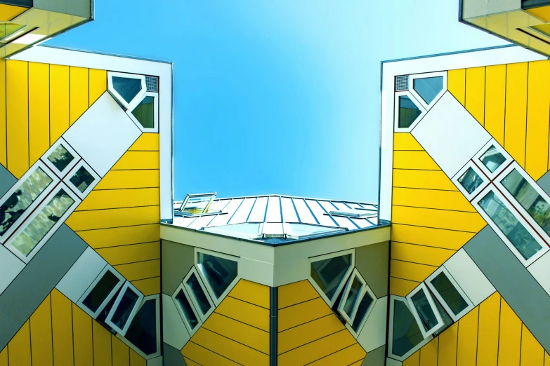an upward perspective of a building with some mirrors on it
