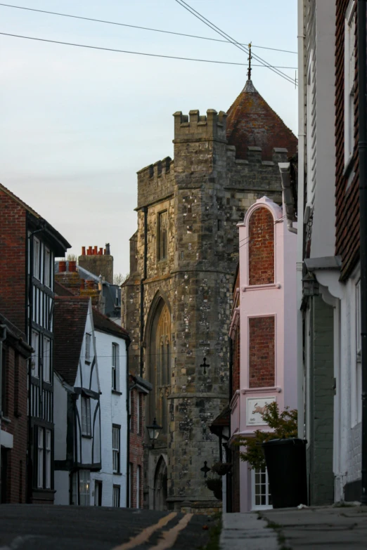 the castle style building with arched doorway is near another building