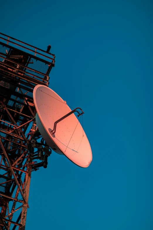 there is a satellite dish that is on the top of a tower