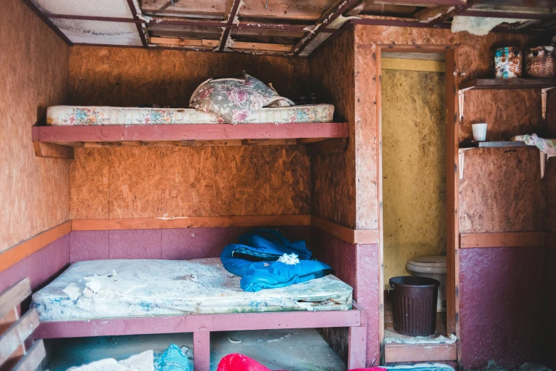 a messy bunk bed in a small room