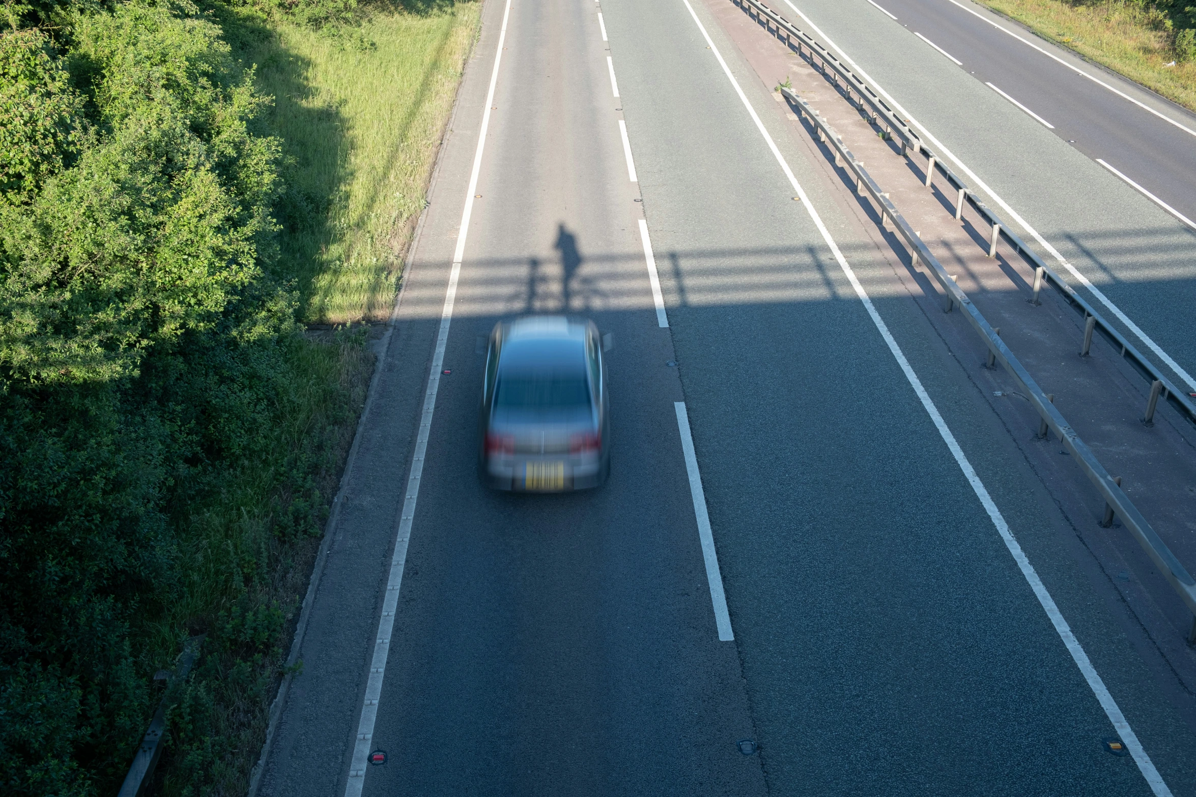 a car traveling down a highway on top of a road