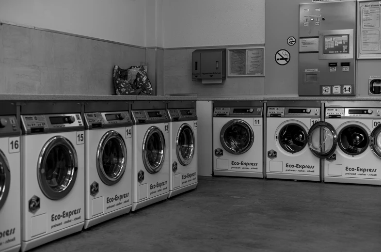 an old po of several washing machines in a room