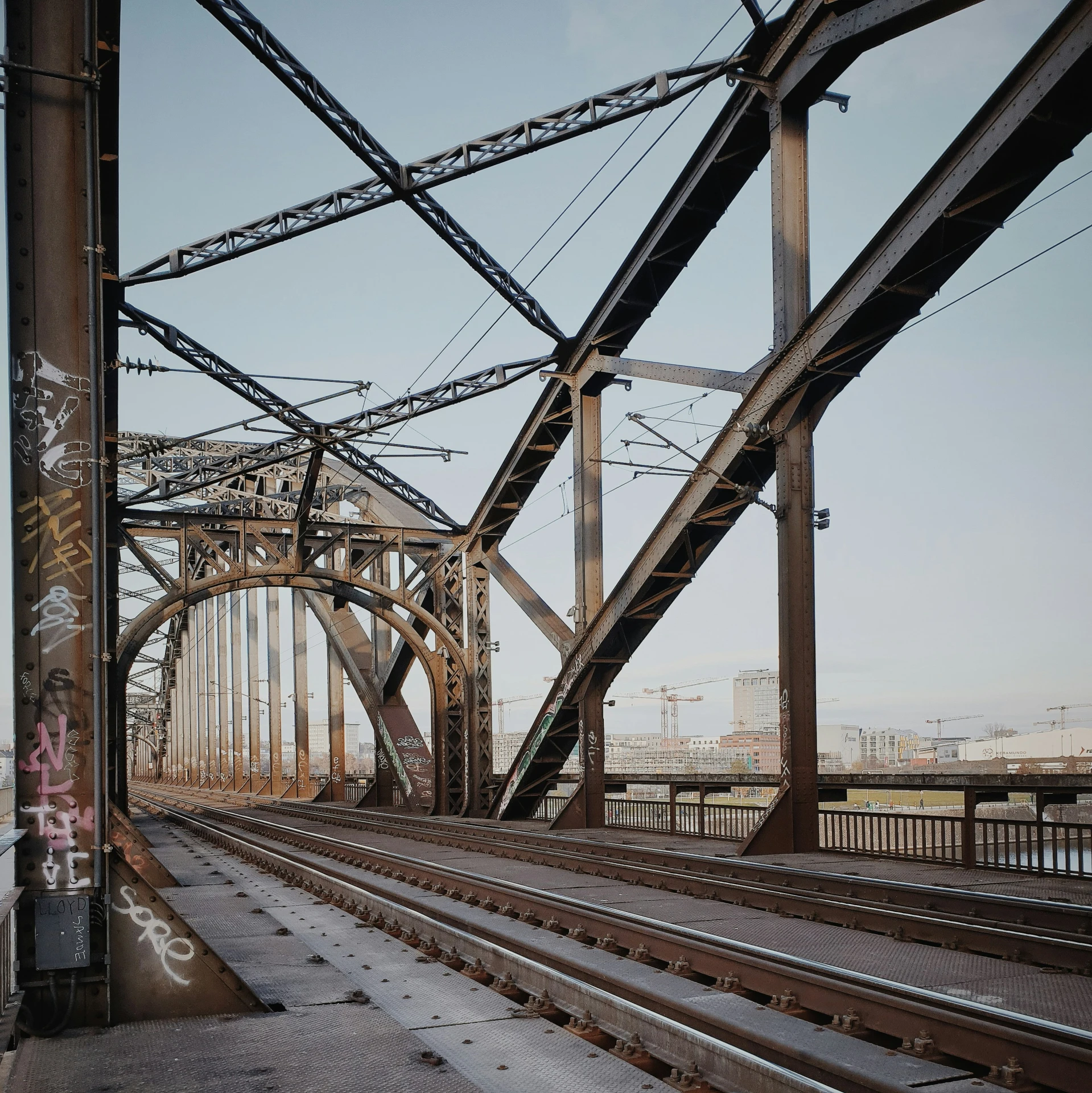 an industrial area with steel bridge lines and graffiti