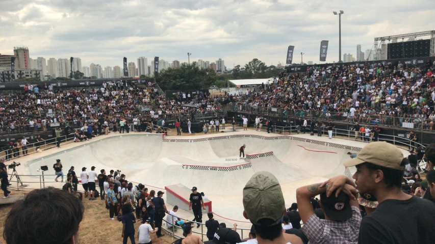 a crowded stadium stands over a skateboard park while people watch from the stands