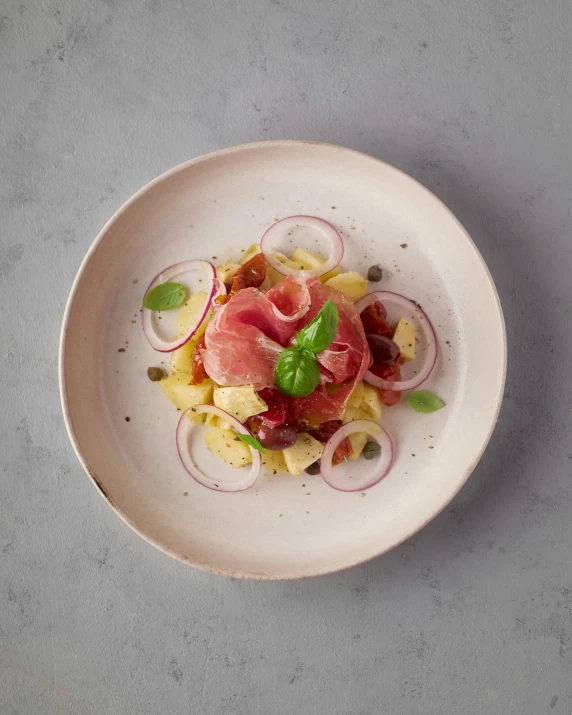 a small plate on a table with food and garnish