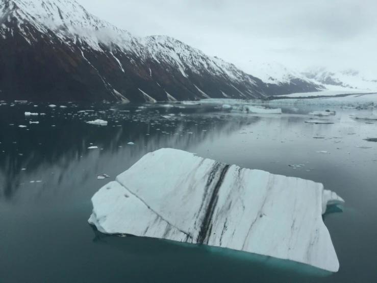 an iceberg floats in the middle of a lake