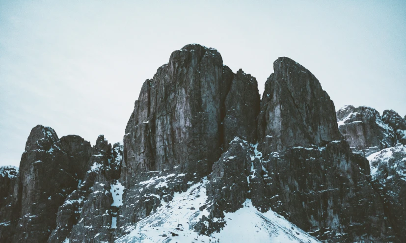 snowy rocks and snow covered mountains with skis on them