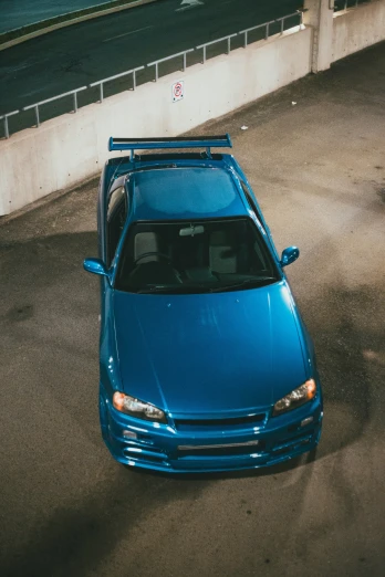 the car with a blue paint job parked on the side of a road