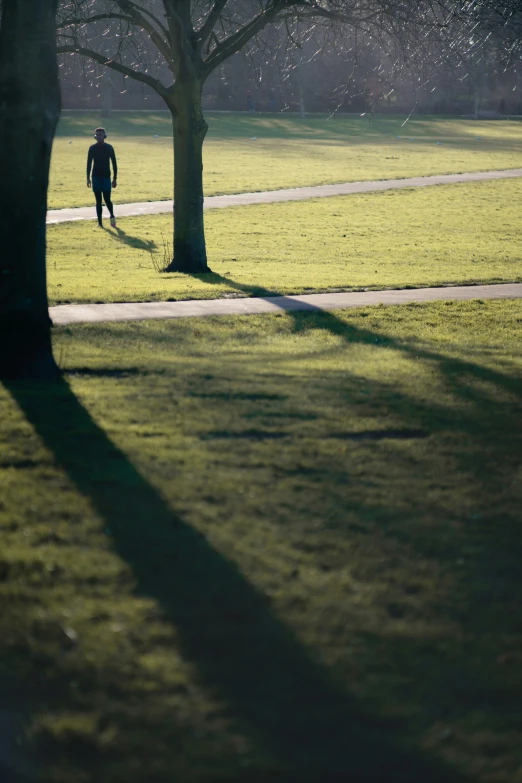 a person walking around with their shadow on the ground