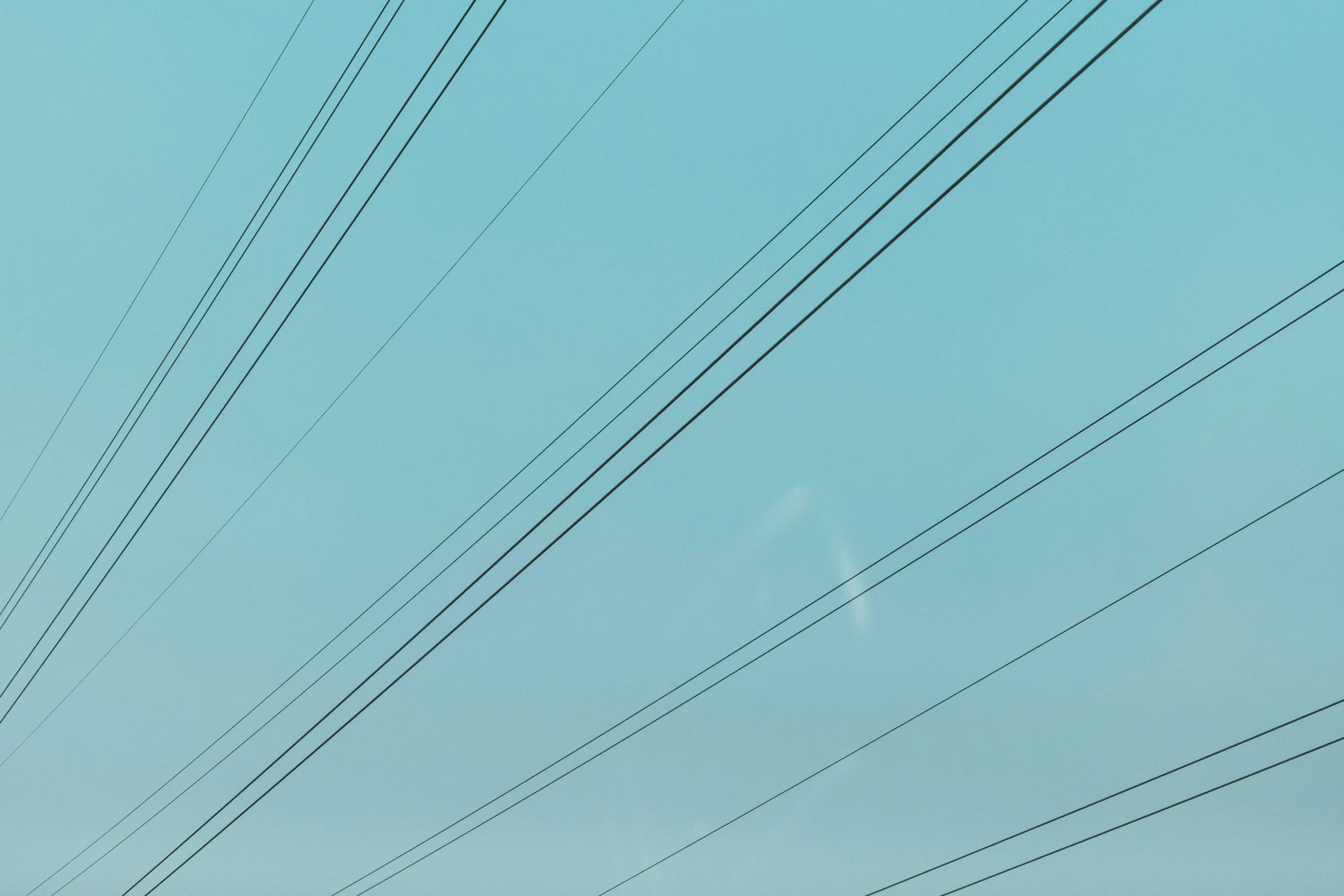 lines from an electric pole stretching to the sky