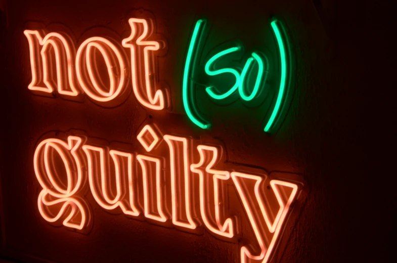 a neon sign is lit up in an dim room