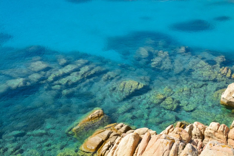 clear blue water surrounded by rocks and rocks