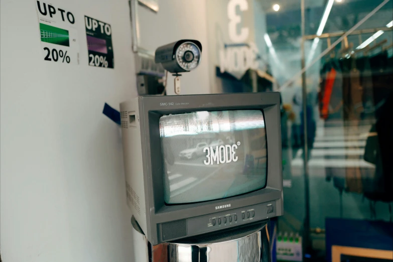 a small black tv sits on top of a metal stand