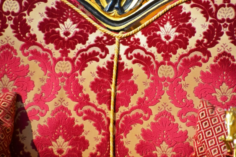 a pattern in a red and gold colored dress
