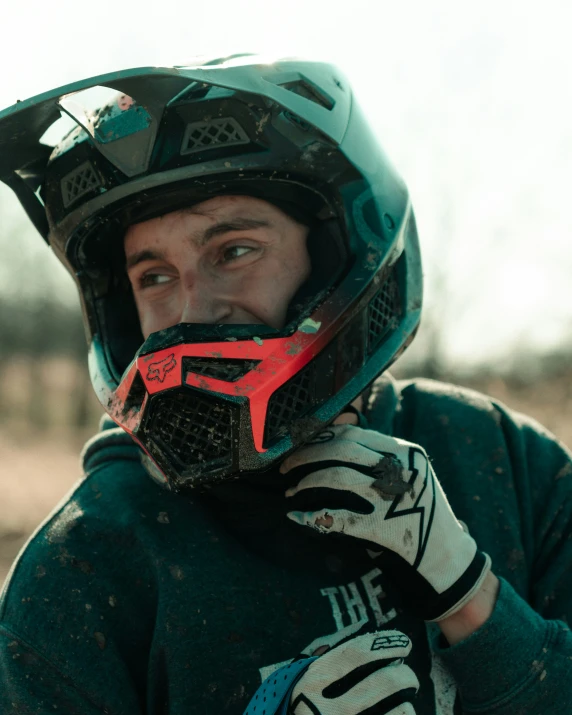 a man wearing a green jersey and wearing a helmet and gloves