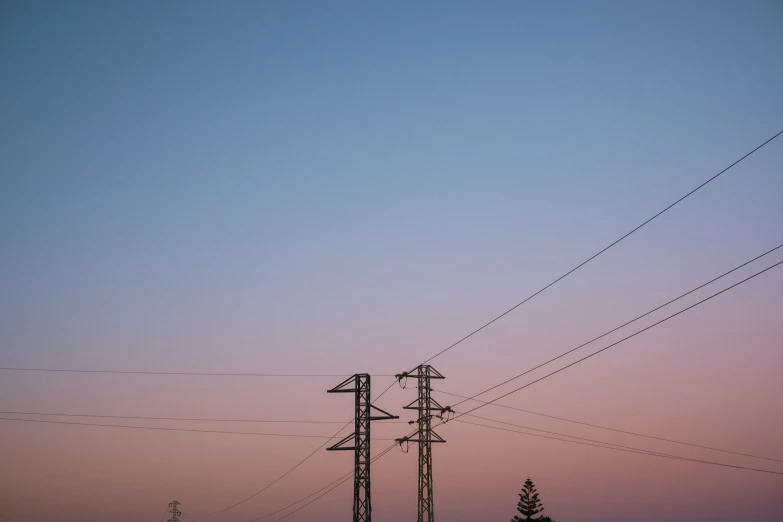 there are many electrical poles high up in the sky