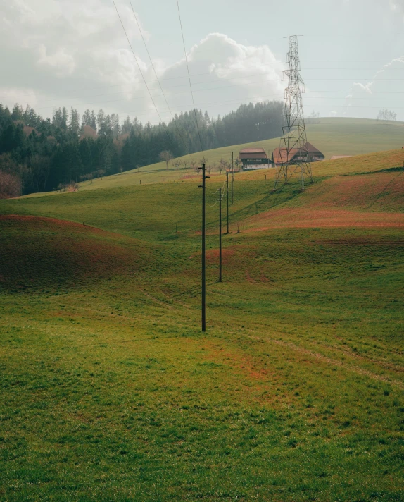 an empty hill with telephone poles on it