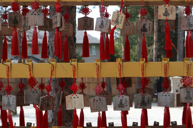 chinese paper, paper towels and other decorations are hanging on a wall