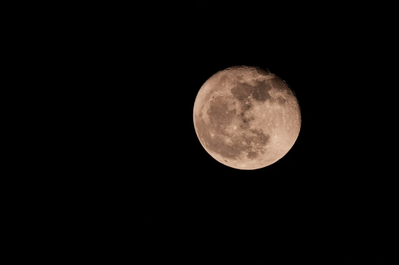 full moon seen across the sky during night time