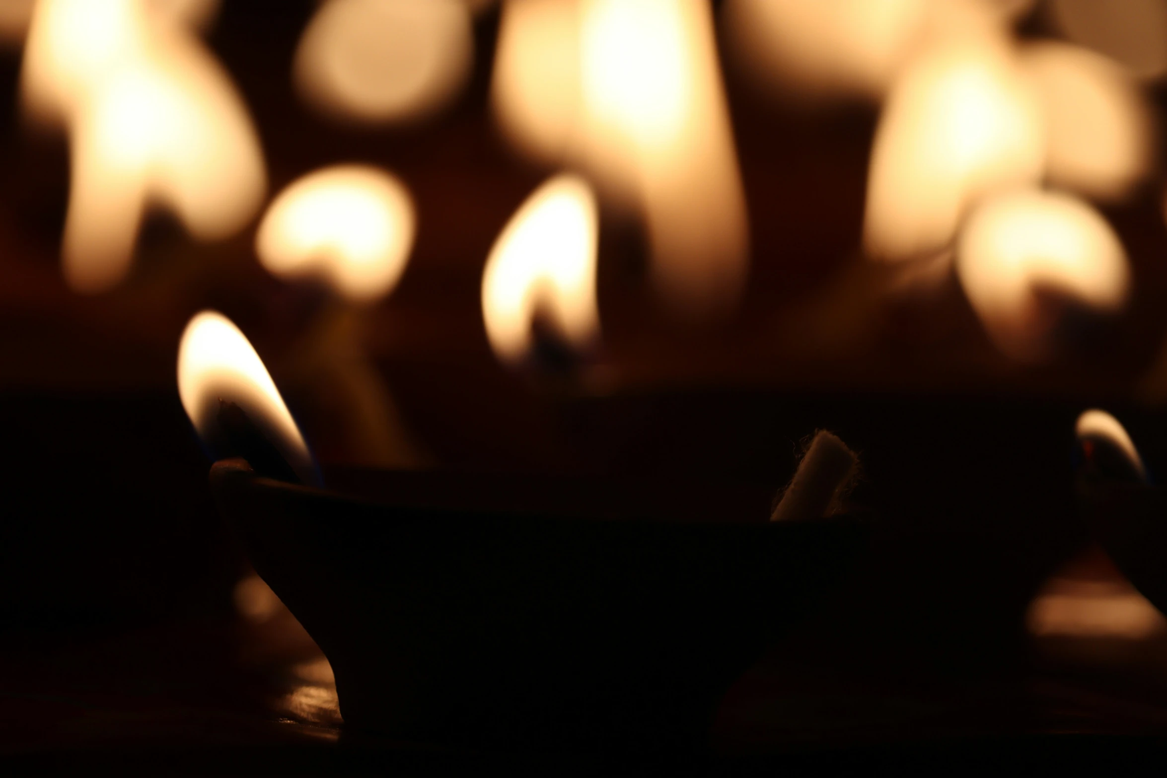 several small lit candles are on a table