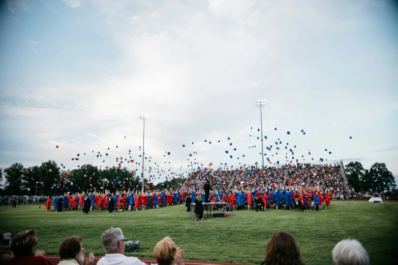 the large group of graduates is in blue and red