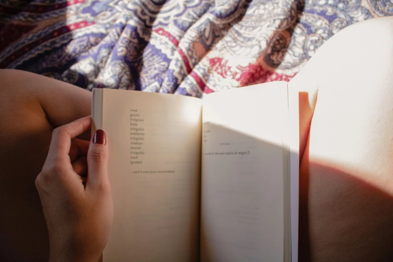 a hand holding a book open to reveal a page