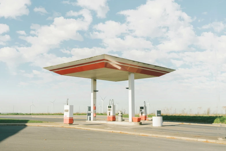 an empty gas station with a few signs on the side