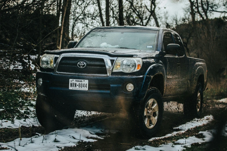 a pickup truck is shown driving through the snow