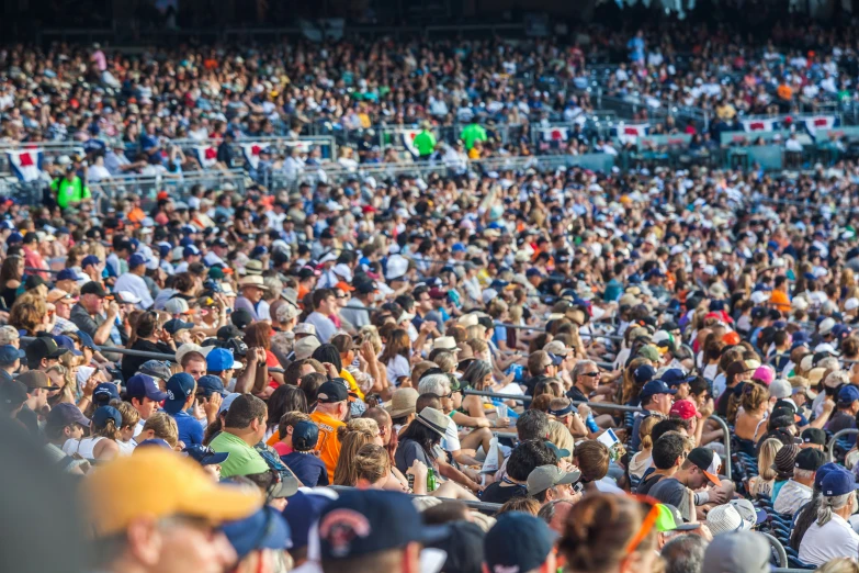 a large group of people are sitting in the stands