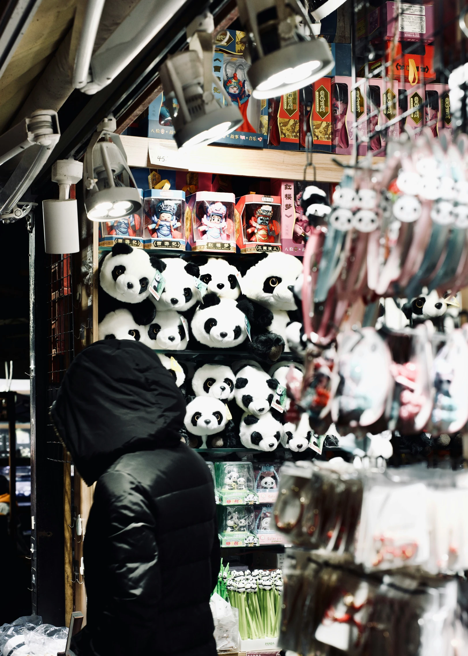 a store selling a lot of panda heads in front of a vendor