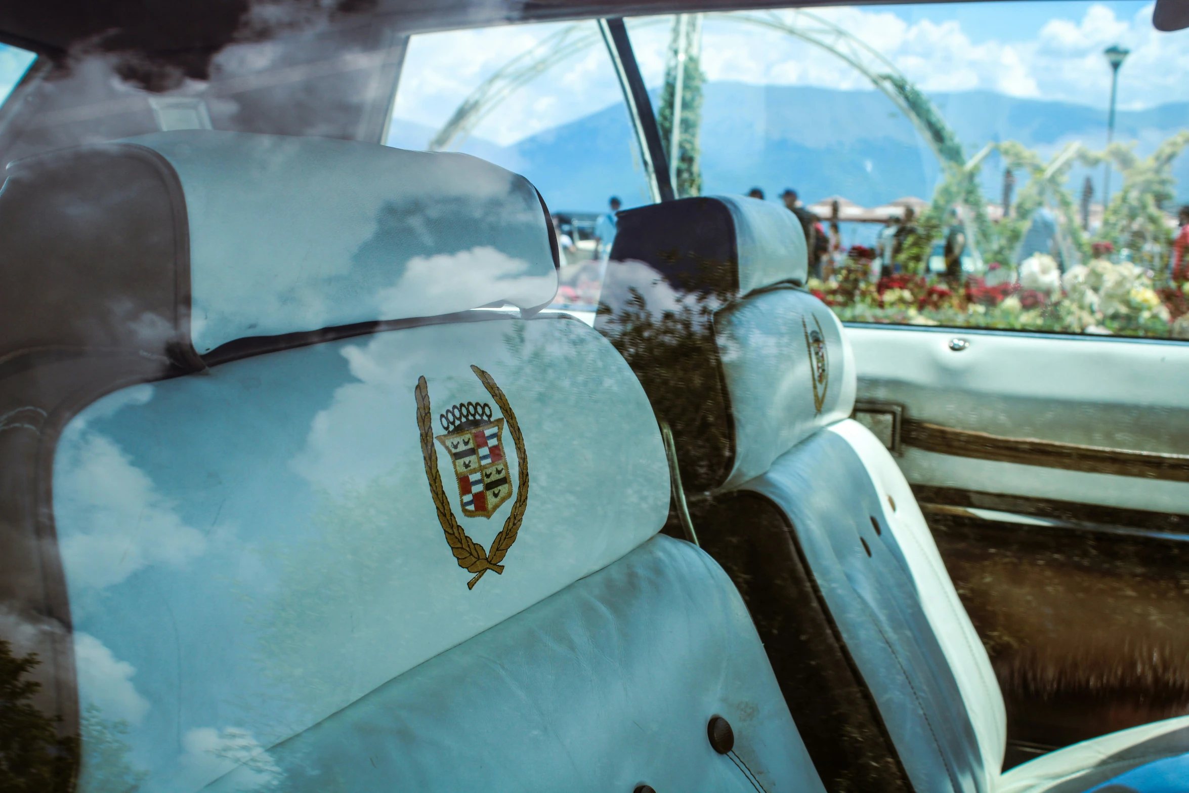 a car with many seats is painted white and gold