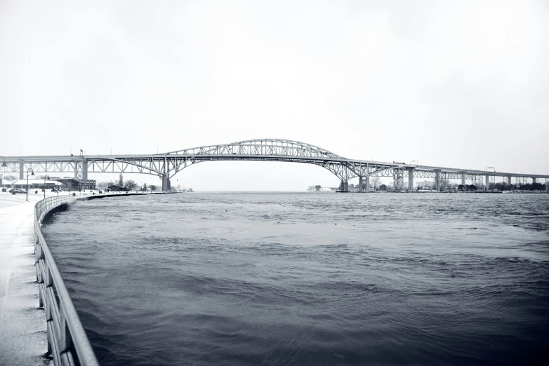 a bridge over some water with a truck on the road