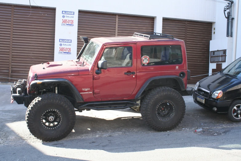 a jeep is parked in front of a garage door