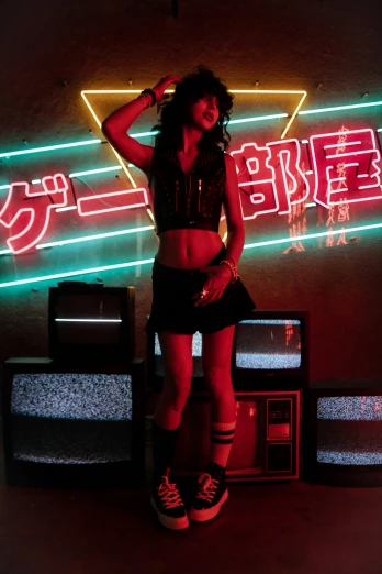 a woman is standing in front of a neon sign